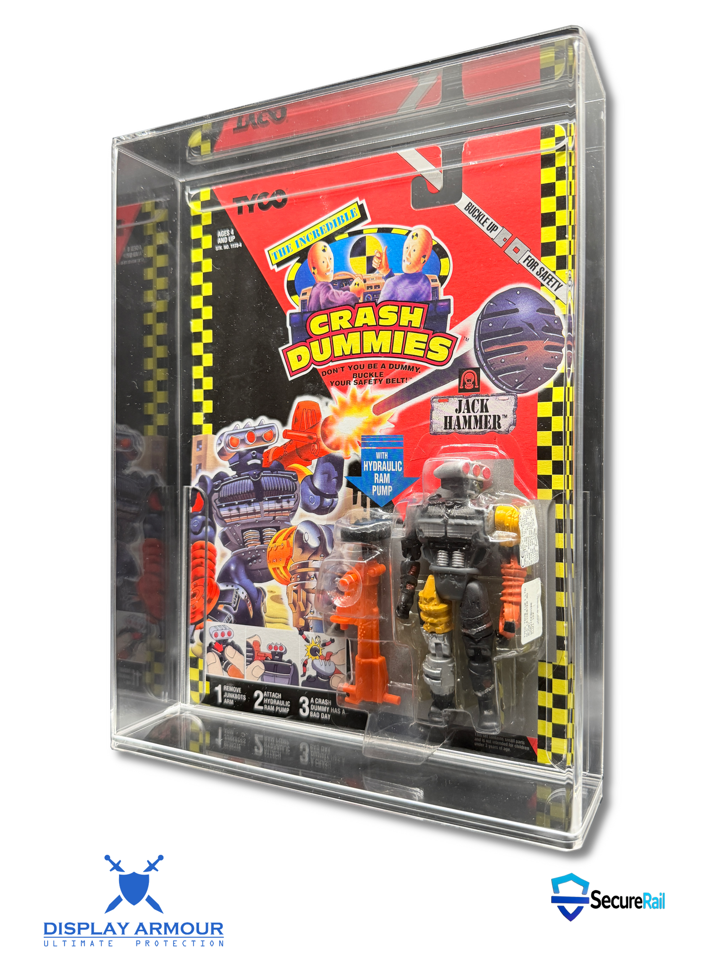 A packaged Crash Dummies action figure set inside a clear acrylic display case, photographed on a white background with Display Armour and Secure24 logos at the bottom.