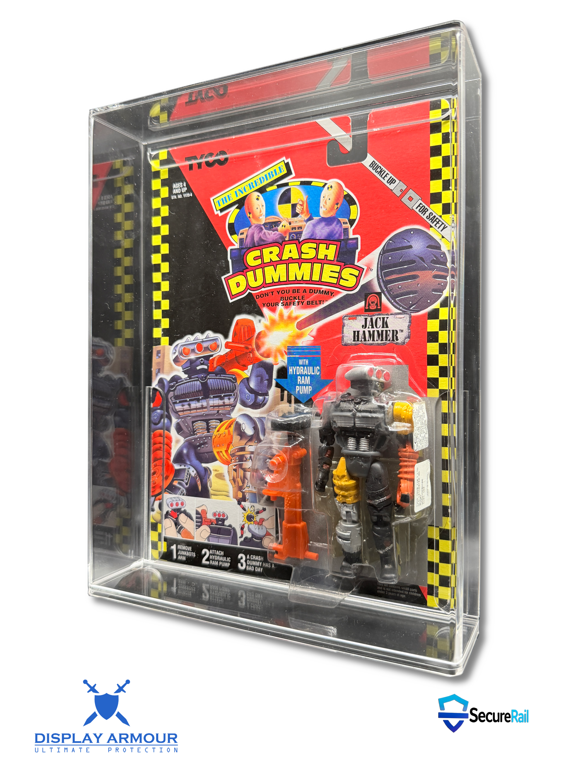 A packaged Crash Dummies action figure set inside a clear acrylic display case, photographed on a white background with Display Armour and Secure24 logos at the bottom.