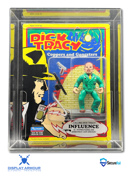 A sealed vintage Dick Tracy action figure in a clear plastic display case. The figure is wearing a green suit and stands beside its illustrated card backing, which features Dick Tracy artwork and the text 'Calling Dick Tracy Influence.